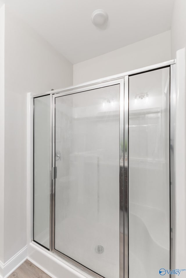 4018 SE Rockland Cir, Owens Cross Roads, AL 35763 - bathroom featuring a shower stall, baseboards, and wood finished floors