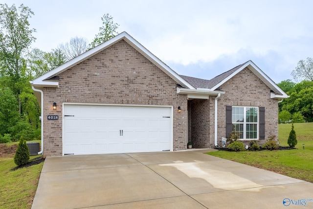 4018 SE Rockland Cir, Owens Cross Roads, AL 35763 - view of front of property with brick siding, concrete driveway, a garage, a front yard, and central air condition unit