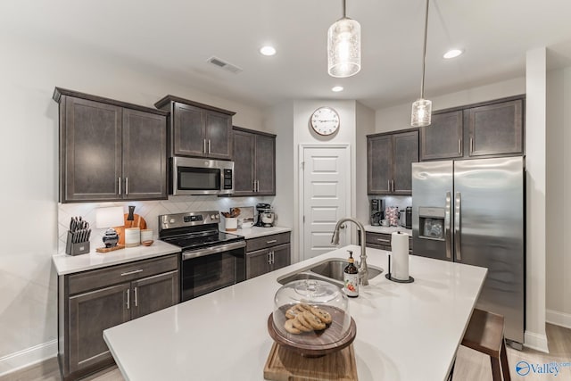 4018 SE Rockland Cir, Owens Cross Roads, AL 35763 - kitchen featuring stainless steel appliances, a sink, dark brown cabinetry, baseboards, and recessed lighting