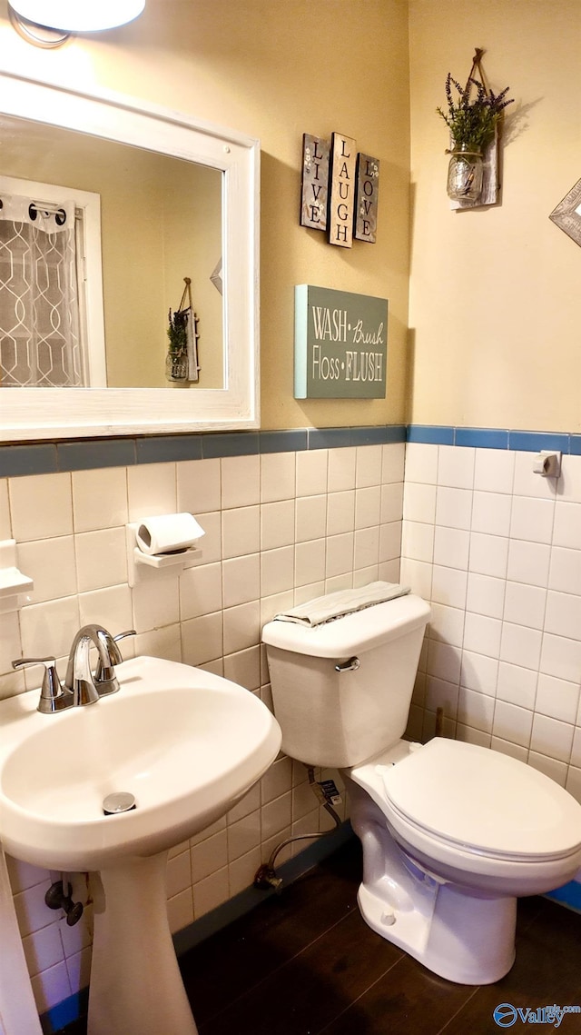 bathroom with hardwood / wood-style floors and toilet