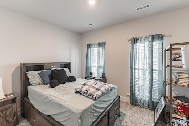 bedroom featuring visible vents, baseboards, and light colored carpet