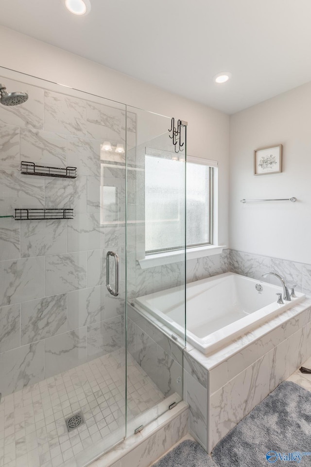 bathroom with recessed lighting, a stall shower, and a bath