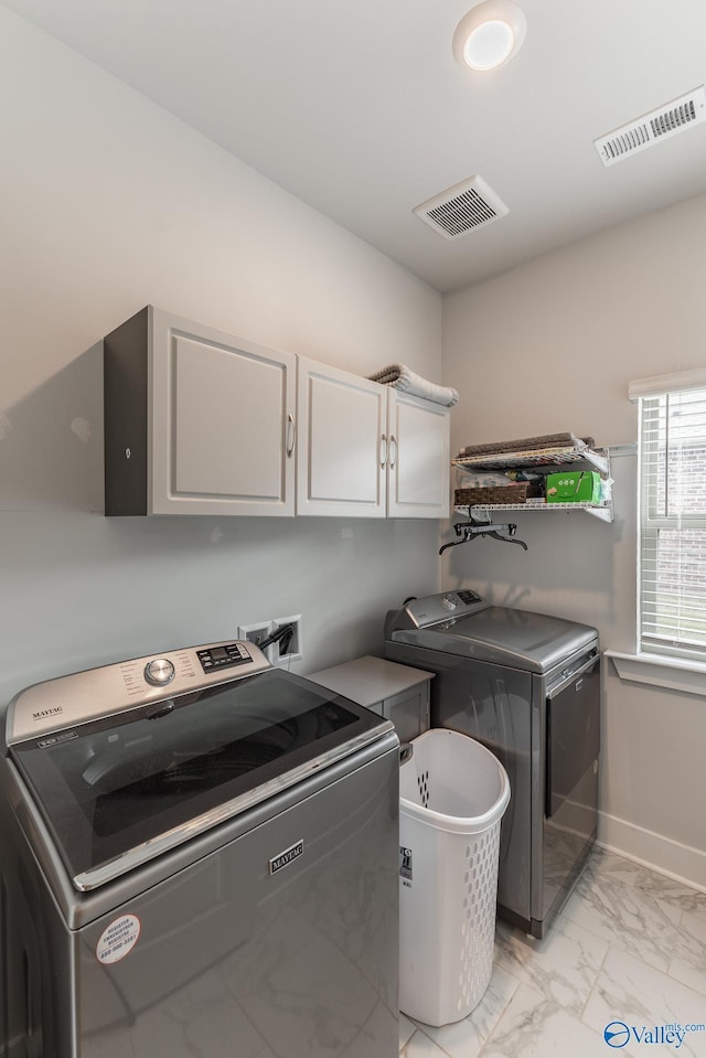 laundry area with visible vents, marble finish floor, cabinet space, and independent washer and dryer