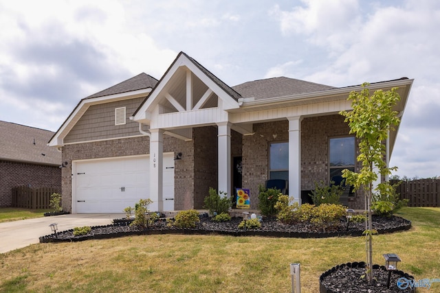 view of front of property featuring a shingled roof, fence, driveway, and a front yard