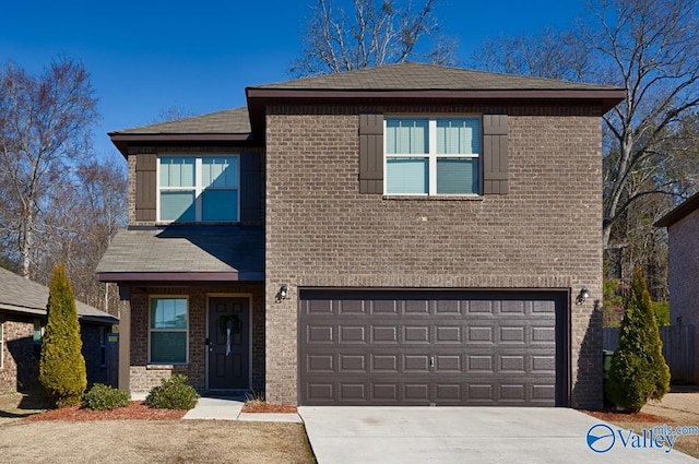 traditional-style house featuring a garage, driveway, and brick siding