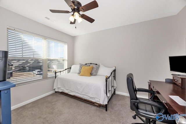 carpeted bedroom featuring visible vents, baseboards, and a ceiling fan