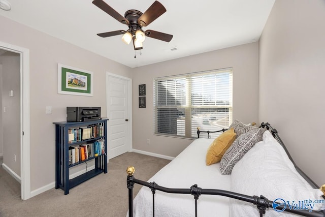 bedroom with light colored carpet, ceiling fan, visible vents, and baseboards