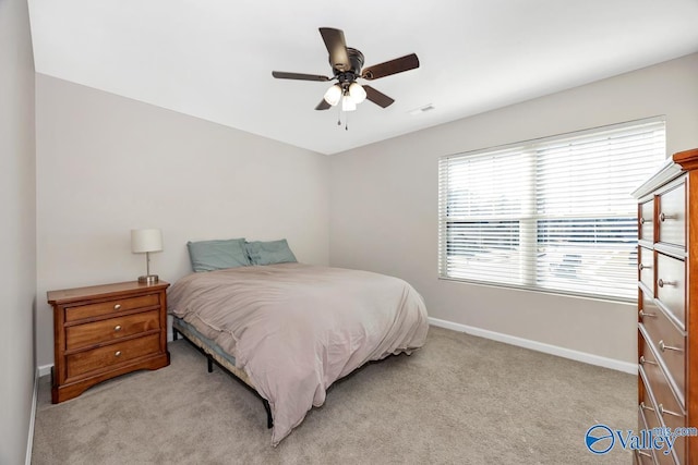 bedroom featuring ceiling fan, baseboards, and light colored carpet