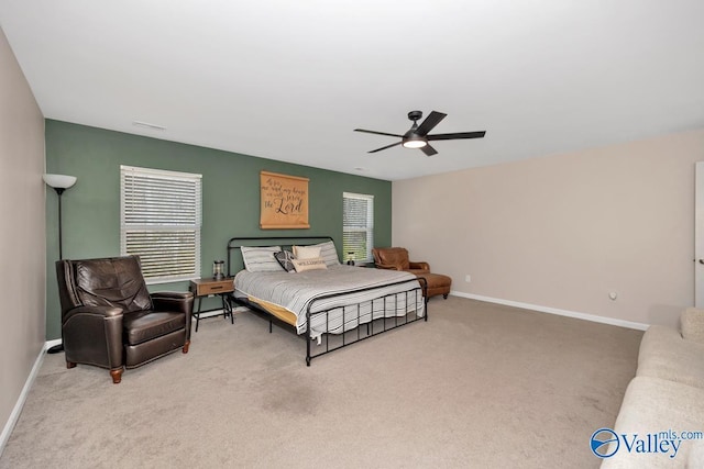 carpeted bedroom featuring baseboards and a ceiling fan