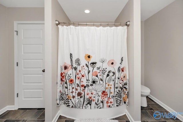 full bathroom with a shower with curtain, tile patterned flooring, baseboards, and toilet