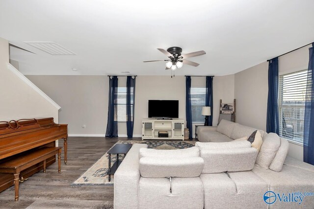 living area with ceiling fan, visible vents, baseboards, and wood finished floors