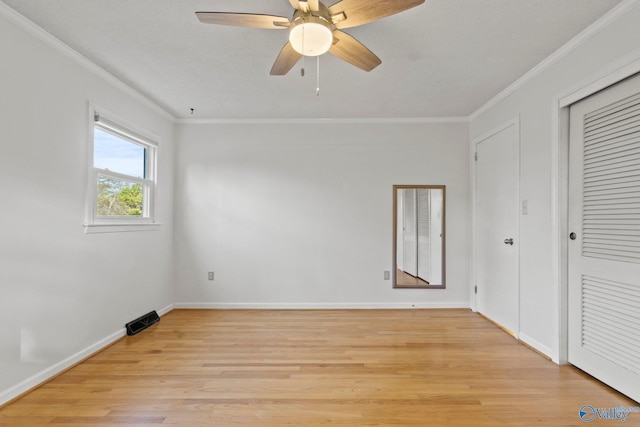 empty room featuring crown molding, ceiling fan, and light hardwood / wood-style floors