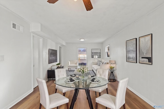 dining space featuring ceiling fan and light hardwood / wood-style flooring