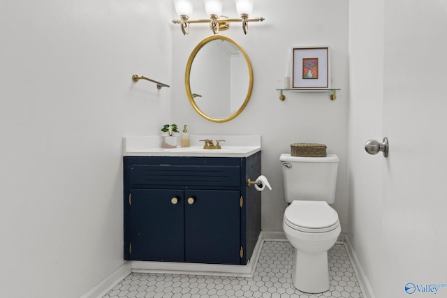 bathroom with vanity, tile patterned flooring, and toilet