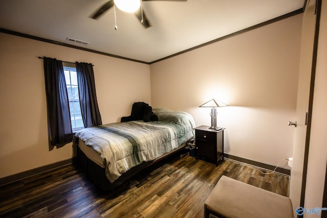 bedroom with ceiling fan, dark hardwood / wood-style floors, and ornamental molding