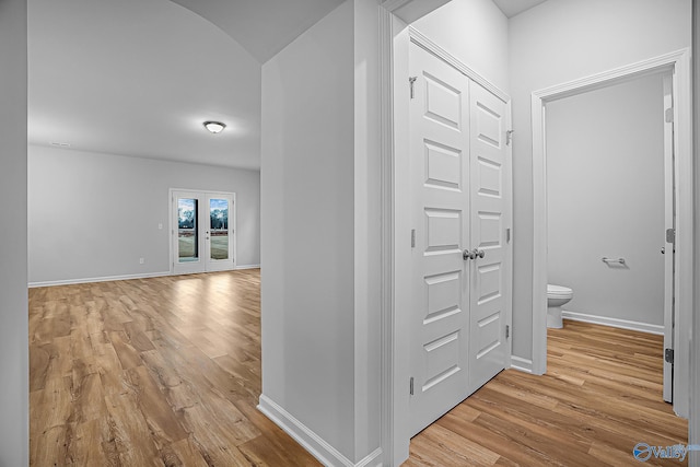 hall featuring french doors and light hardwood / wood-style flooring