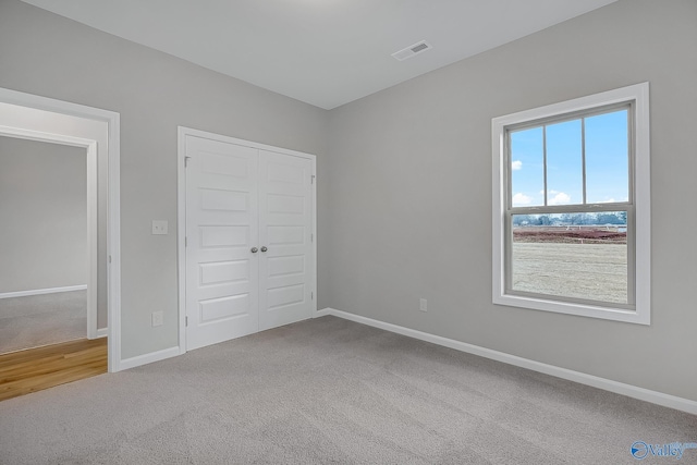 unfurnished bedroom with a closet and carpet