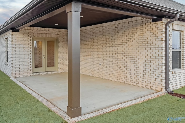 view of side of property with a patio area and french doors