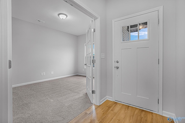 view of carpeted foyer entrance