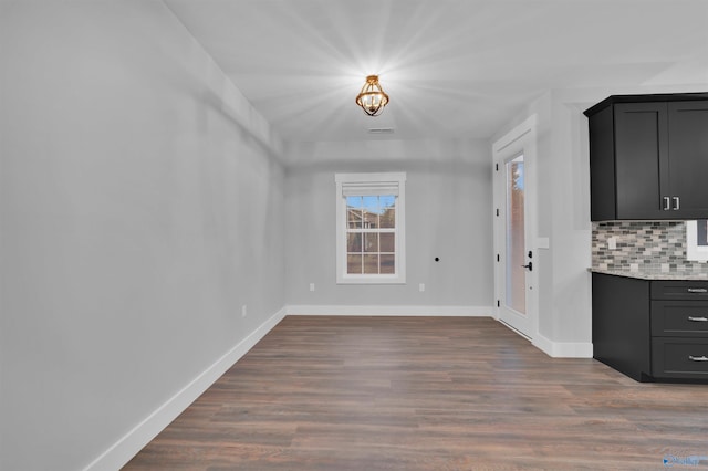 unfurnished dining area with dark hardwood / wood-style flooring