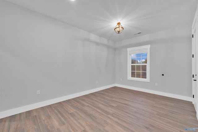 unfurnished room with hardwood / wood-style flooring