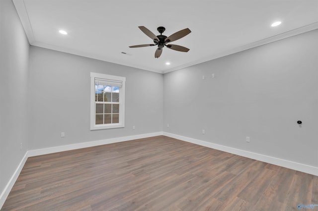 empty room with crown molding, dark wood-type flooring, and ceiling fan