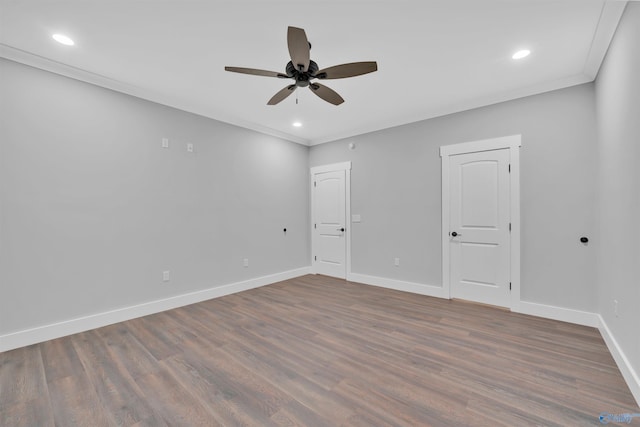 empty room featuring crown molding, ceiling fan, and dark hardwood / wood-style flooring