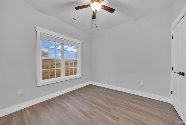 empty room with ceiling fan and dark hardwood / wood-style flooring