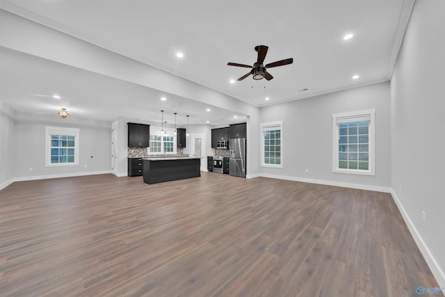 unfurnished living room featuring crown molding, dark wood-type flooring, and ceiling fan