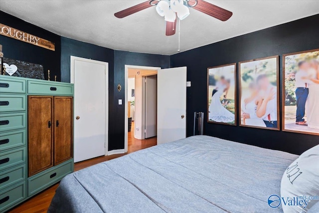 bedroom featuring ceiling fan and dark hardwood / wood-style flooring