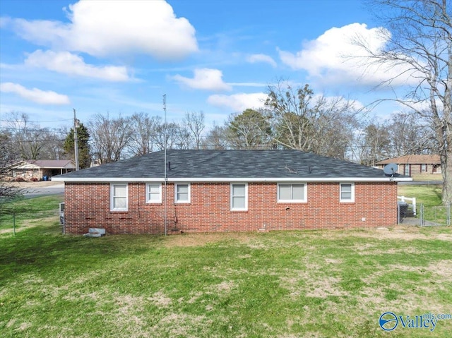 rear view of house featuring a yard