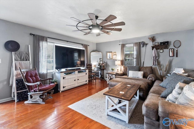 living room featuring ceiling fan and hardwood / wood-style flooring