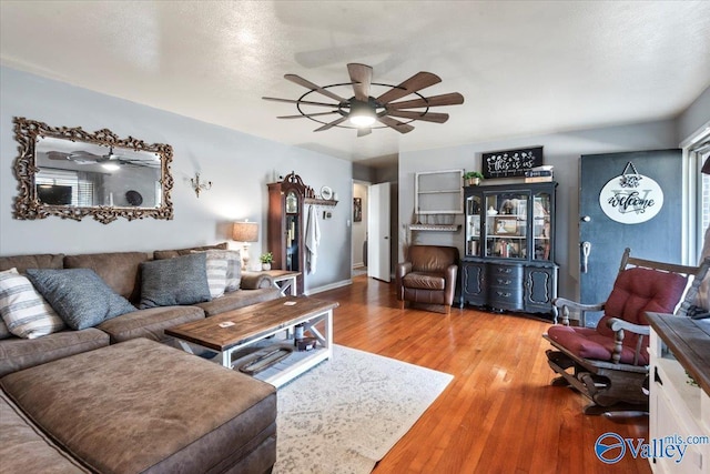 living room with hardwood / wood-style floors and a textured ceiling