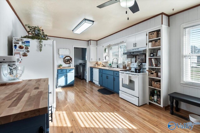 kitchen with white cabinets, light wood-type flooring, white appliances, and ornamental molding