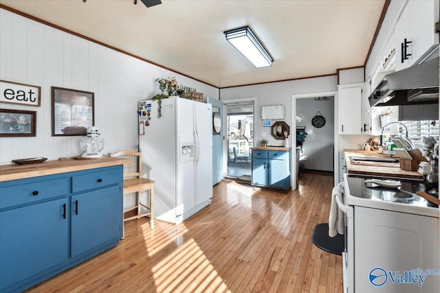 kitchen featuring white appliances, white cabinets, blue cabinetry, butcher block countertops, and crown molding