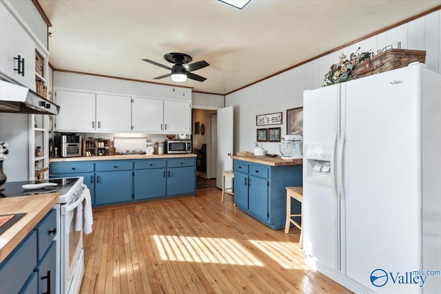 kitchen featuring blue cabinetry, butcher block counters, white appliances, and white cabinetry