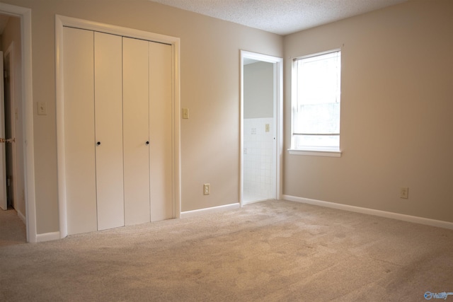 8206 SE Willowbrook Cir Unit B, Huntsville, AL 35802 - unfurnished bedroom featuring carpet flooring, a textured ceiling, and a closet
