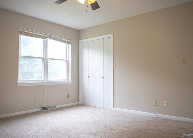 8206 SE Willowbrook Cir Unit B, Huntsville, AL 35802 - unfurnished bedroom with carpet flooring, a closet, a ceiling fan, and a textured ceiling