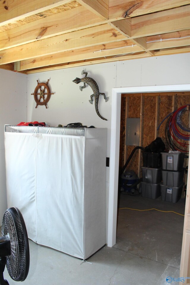 laundry area with electric panel and washer / dryer