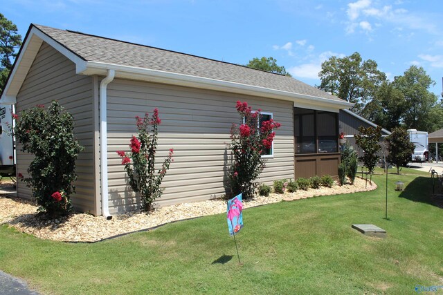 view of side of property with a yard