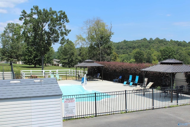 view of swimming pool featuring a gazebo and a patio