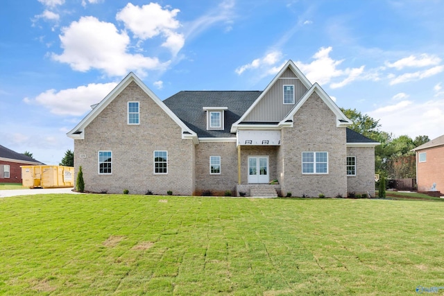 view of front of home with french doors and a front lawn