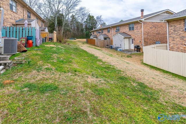 view of yard with cooling unit and a storage shed