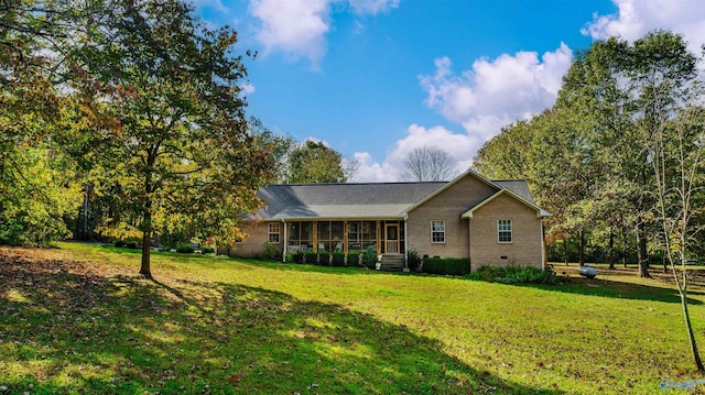 ranch-style house featuring a sunroom and a front yard