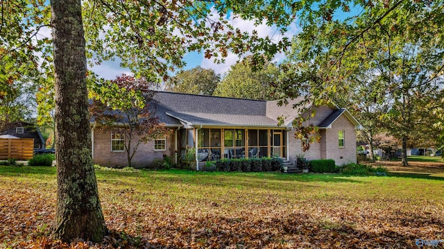 view of front of house featuring a front lawn and a sunroom