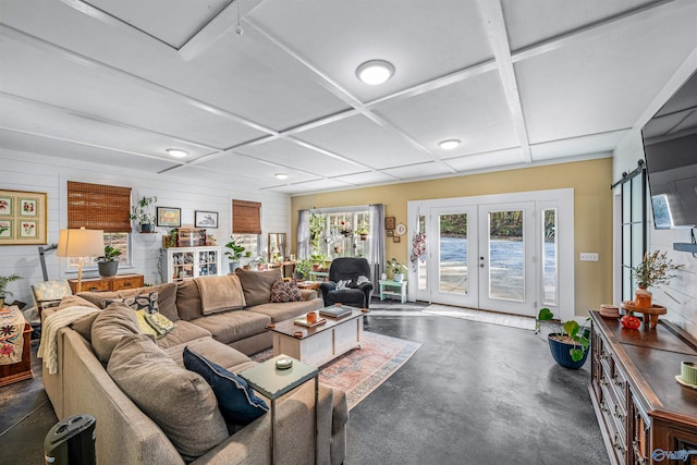 living room featuring a barn door and french doors