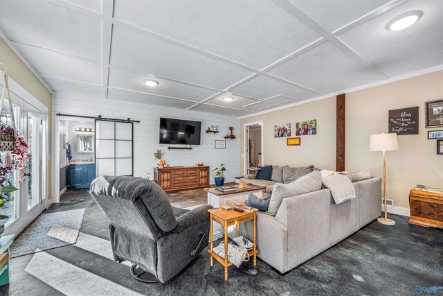 living room featuring a barn door and coffered ceiling