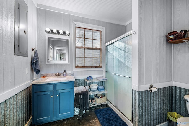 bathroom featuring vanity, a shower with door, concrete floors, electric panel, and wood walls