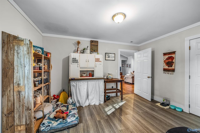 interior space with ornamental molding and hardwood / wood-style flooring