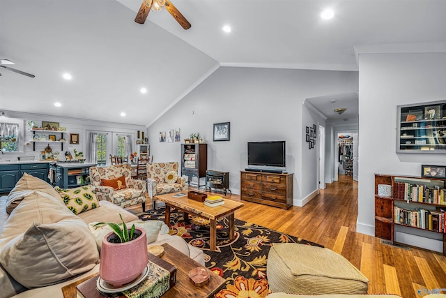 living room with light hardwood / wood-style floors, high vaulted ceiling, ceiling fan, and ornamental molding